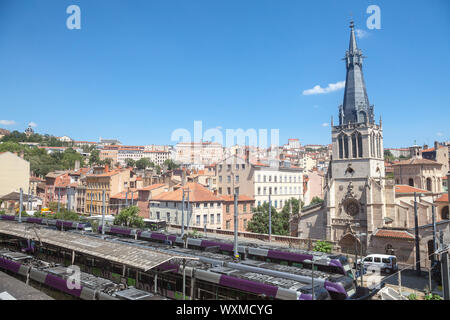 LYON, FRANCE - JULY 14, 2019: Eglise Saint Paul de Lyon Church facing the plaftorms of Gare de Lyon Saint Paul Trail Station full of trains ready for Stock Photo