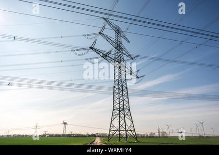 Power pole with many power cables in front of blue sky Stock Photo