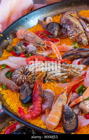 Vertical photo of delicious paella seafood rice recipe of Spain Stock Photo