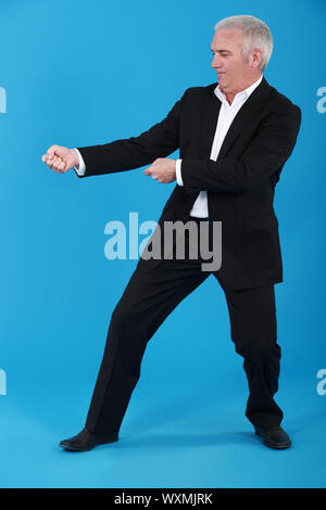 Businessman pulling invisible rope Stock Photo - Alamy