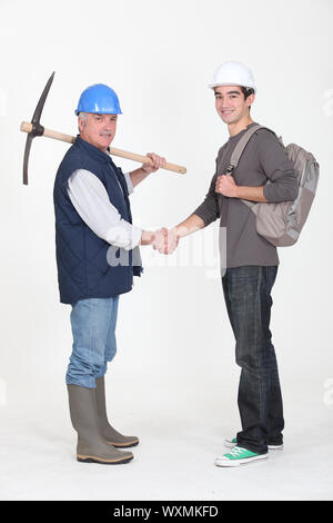 Experienced tradesman meeting his new apprentice for the first time Stock Photo