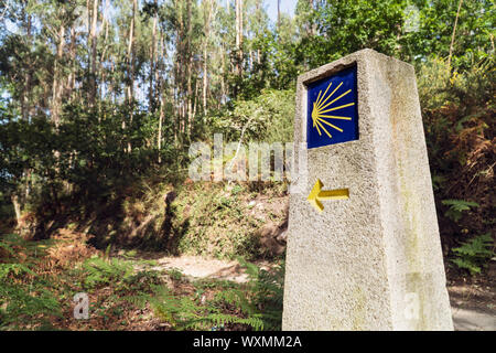 Way of St. James milestone. Yellow scallop sign pilgrimage to Santiago de Compostela Stock Photo