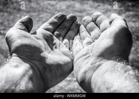 Begging dirty hands as a sign of poverty Stock Photo