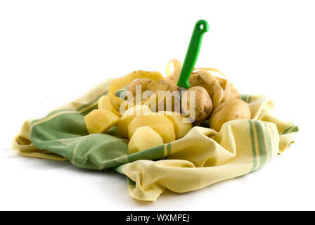 peeling potatoes with a green peeler Stock Photo