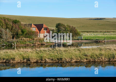 Exceat and the South Downs, near Seaford, East Sussex, South East England, with the boathouse of the Cuckmere Valley Canoe Club and oxbow lake Stock Photo