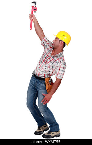 Laborer trying to hang on with a caliper Stock Photo