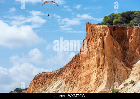 Cliffs and paragliders at the Praia de Falésia at Albufeira in Portugal Stock Photo