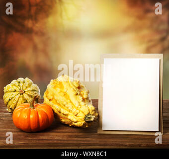 Squashes and greeting card on fall seasonal background