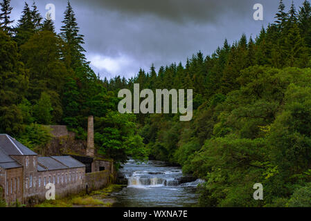 Falls on The River Clyde in Forest at New Lanark With Old Mill Buildings on the Bank Stock Photo