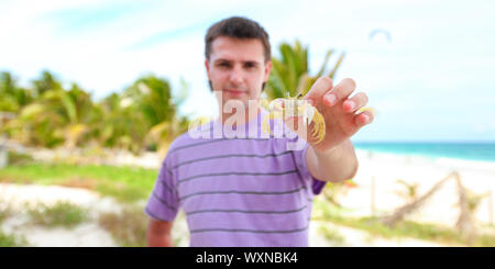 Close up of man's hand holding crab Stock Photo