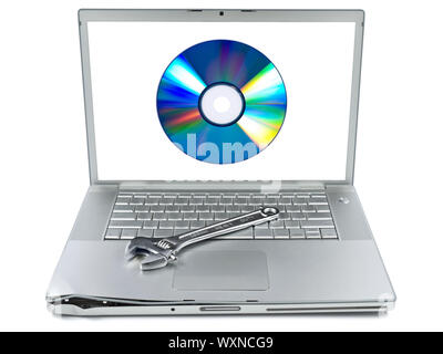 Damaged laptop with a spanner over it and a digital disc on the screen. Isolated on white. Stock Photo