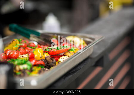 Freshly cooked hot and spicy grilled vegetables in metallic bowl Stock Photo