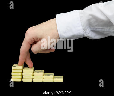 Ascension on a pedestal from dominoes counters Stock Photo