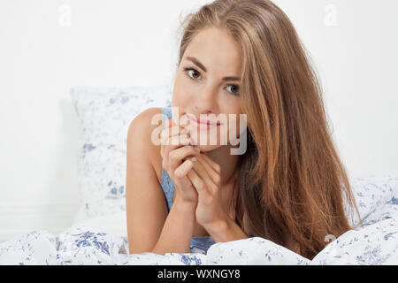 young brunette woman lying in bed sleeping morning Stock Photo