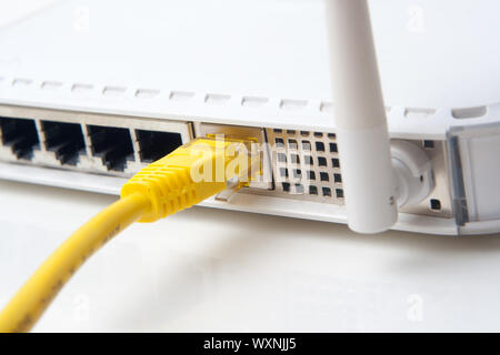 Wireless lan router with yellow network cable Stock Photo