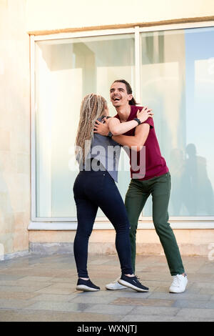 Young couple enjoying first date, dancing outdoors Stock Photo