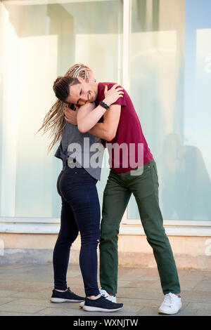 Young couple enjoying first date, dancing outdoors Stock Photo