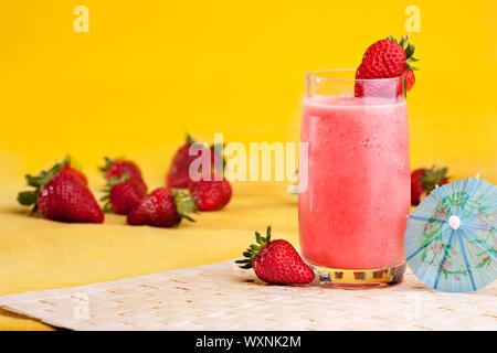 A fresh summer strawberry drink isolated on yellow Stock Photo