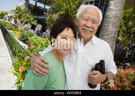 Smiling Couple with Binoculars Stock Photo