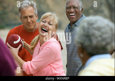 Friends Playing Football Together Stock Photo