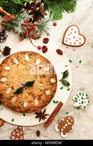 Homemade Christmas fruitcake on festive Xmas holiday background top view Stock Photo