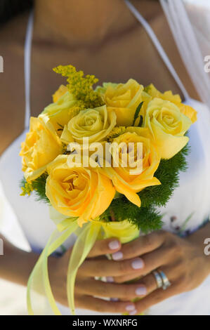 Close-up of Bride With Yellow Rose Bouquet Stock Photo