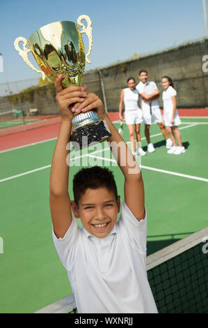 Boy Holding Tennis Trophy Stock Photo