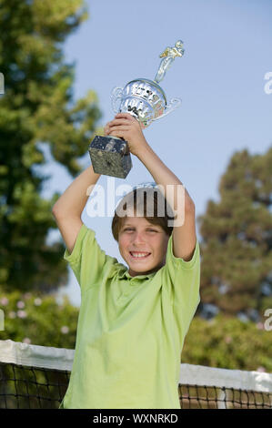 Boy Holding Tennis Trophy Stock Photo