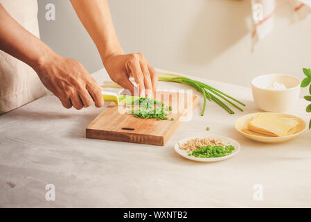 Wrapping Wonton and raw ingredients isolated at kitchen Stock Photo
