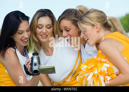 Cheerleaders Watching Video on Videocamera Stock Photo