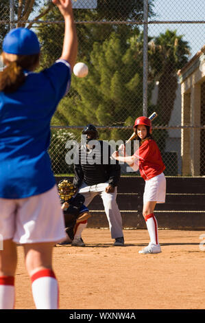 Pitcher Throwing Softball Towards Batter Stock Photo