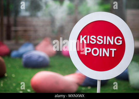 Kissing point sign in park with pillows for people outdoor Stock Photo
