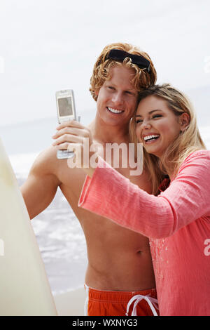 Couple Using Camera Phone Stock Photo