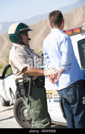 Police officer arresting driver Stock Photo - Alamy