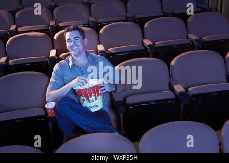 Man Watching Movie in Empty Theater