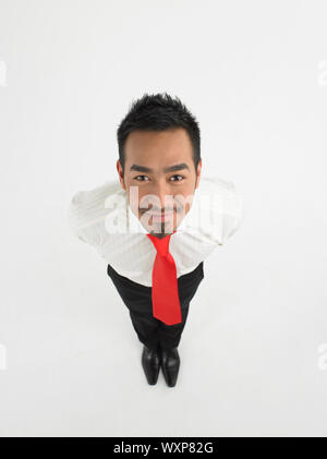 Full length portrait of a smiling male executive against white background Stock Photo
