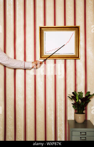 Man Pointing to Graph Showing Upward Growth Stock Photo