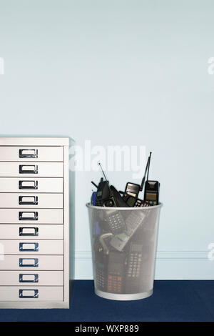Cell Phones Thrown Away in Garbage Can Stock Photo