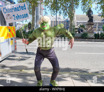London, UK. 17th September 2019.  Demonstrator holding protest outside the Supreme Court, waiting for the ruling on the Legal challenge to the Prorogation of parliament. Pro defend democracy supporter in Hulk costume and Johnson wig holding silence protest, with sign  'Chlorinated Johnson' waiting for answer to challenge of legality of shut down  in wake of Brexit deadline . Credit: JF Pelletier/Alamy Live News. Stock Photo