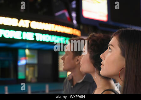 Friends waiting out of the cinema hall Stock Photo