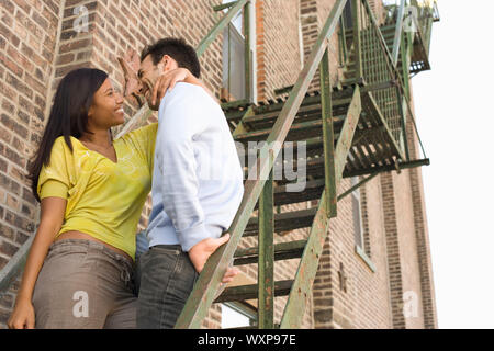 Young Couple on Fire Escape Stock Photo
