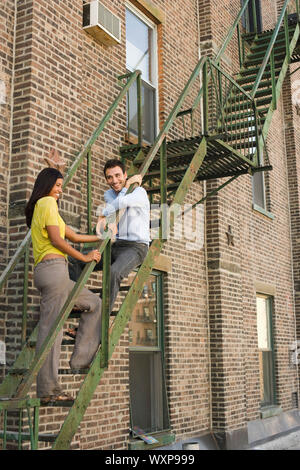 Young Couple on Fire Escape Stock Photo