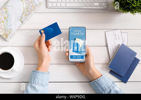 Woman buying plane tickets in Internet via application on smartphone Stock Photo