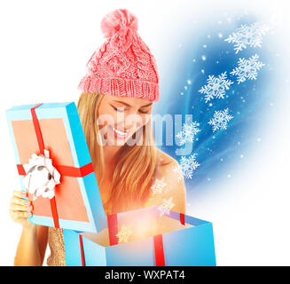 Happy girl receive Christmas present, opened big gift box, many magical snowflake flying from box, fantasy New Year surprise Stock Photo