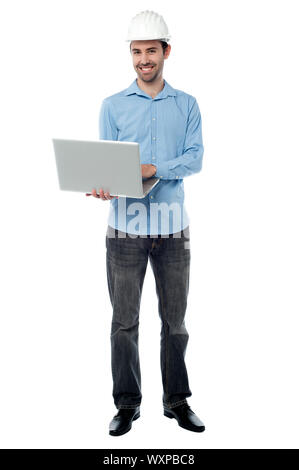 Male architect browsing on his laptop Stock Photo