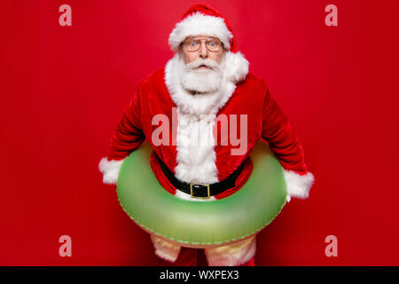 December winter noel christmastime rest relax chill party trip. Scared frustrated mature aged Snta in costume tradition spectacles with white beard Stock Photo