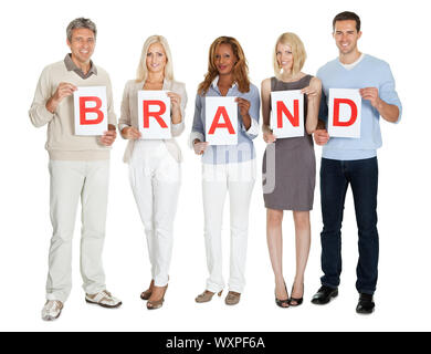 Casual group of people with a brand sign board Stock Photo