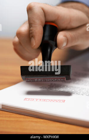 Man Using 'Cancelled' Stamp Stock Photo