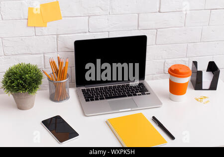 Orange style workplace with laptop on white office table Stock Photo