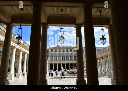 The Palais Royal, view of corridor, columns and hanging lamps in the courtyard. Paris, France. August 16, 2019. Stock Photo